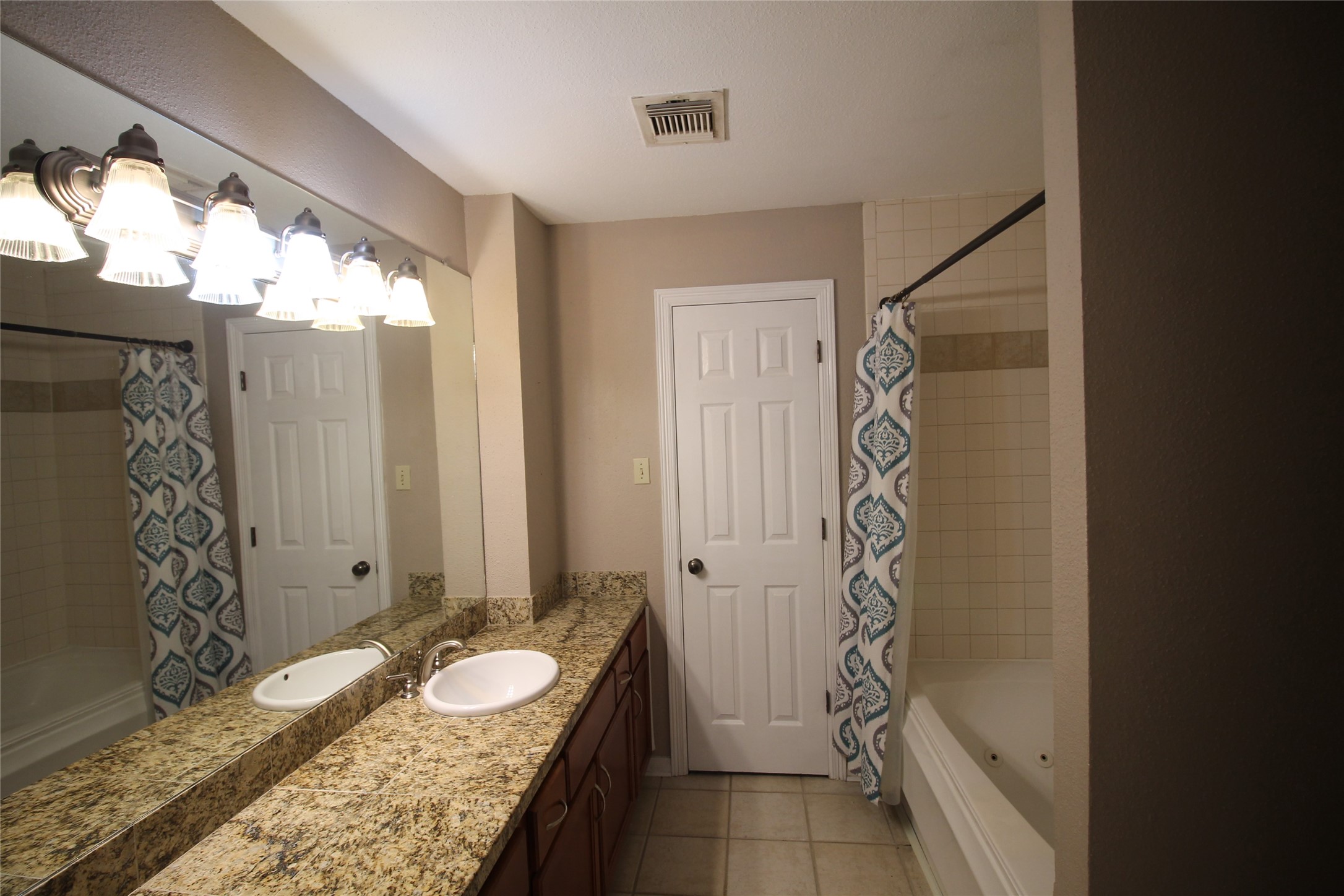 2211 South Kirkwood Road, Unit 59 Houston, TX 77077 - Photo 13 of 16 a bathroom with a granite countertop sink and a mirror