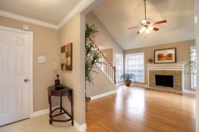 a view of a livingroom with wooden floor and a ceiling fan