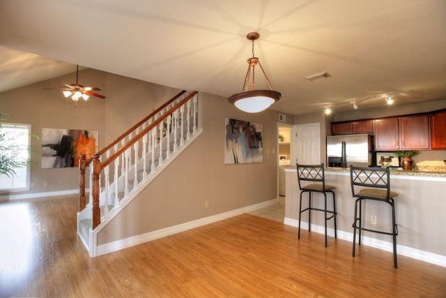 2211 South Kirkwood Road, Unit 59 Houston, TX 77077 - Photo 6 of 16 a view of a livingroom with furniture a dinning room and wooden floor