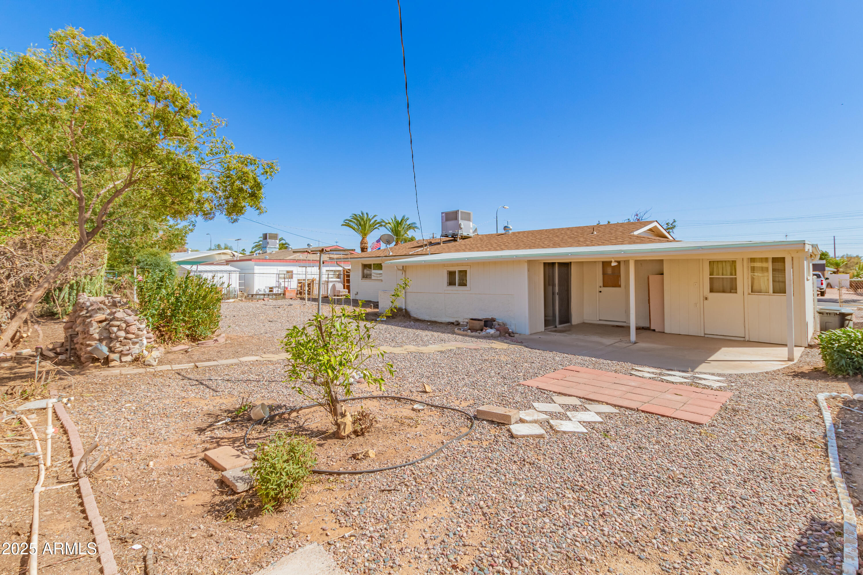 5732 Covina Road Mesa, AZ 85205 - Photo 23 of 24 a view of a white house with a yard