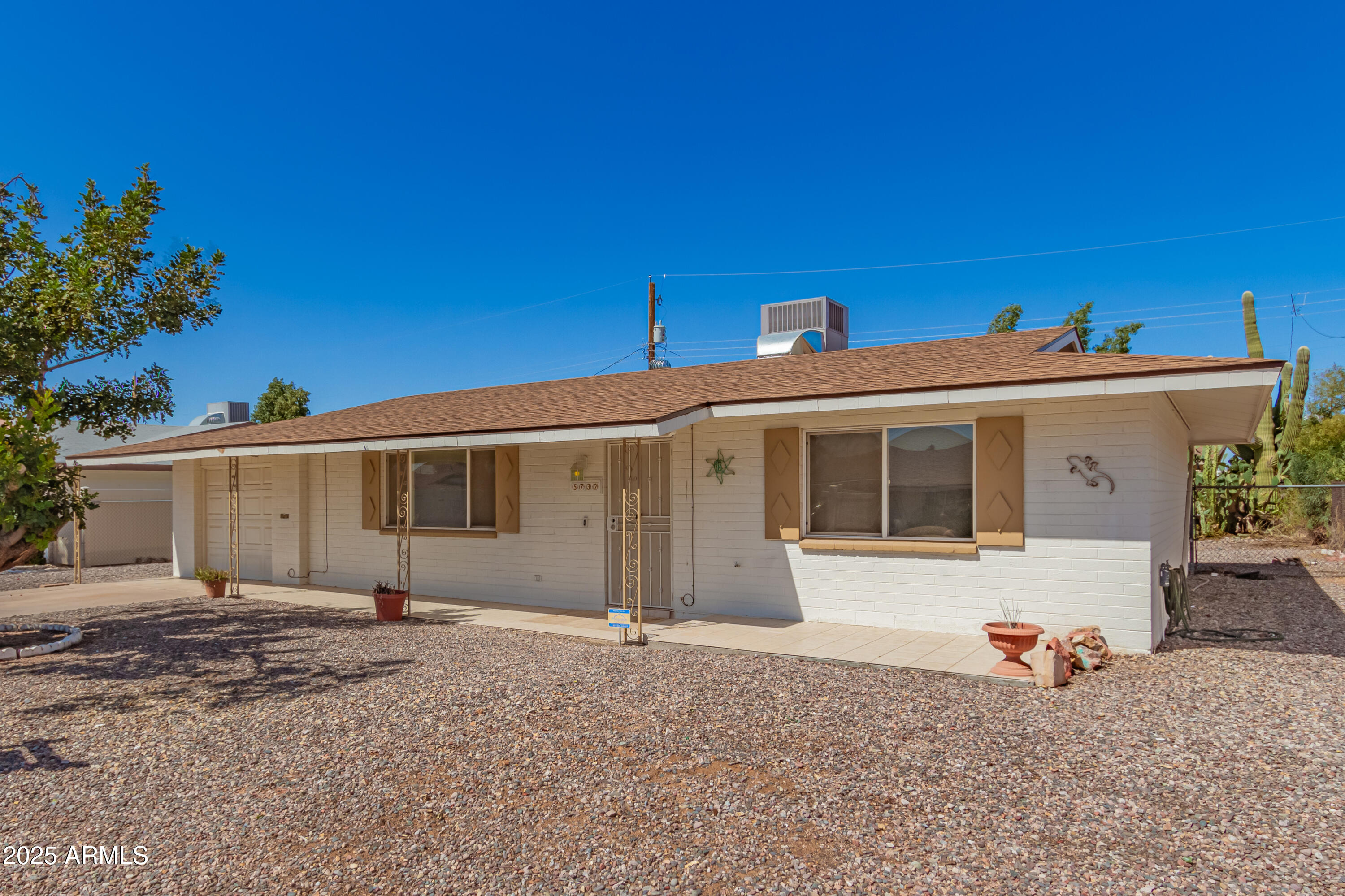 5732 Covina Road Mesa, AZ 85205 - Photo 3 of 24 a front view of a house with a yard