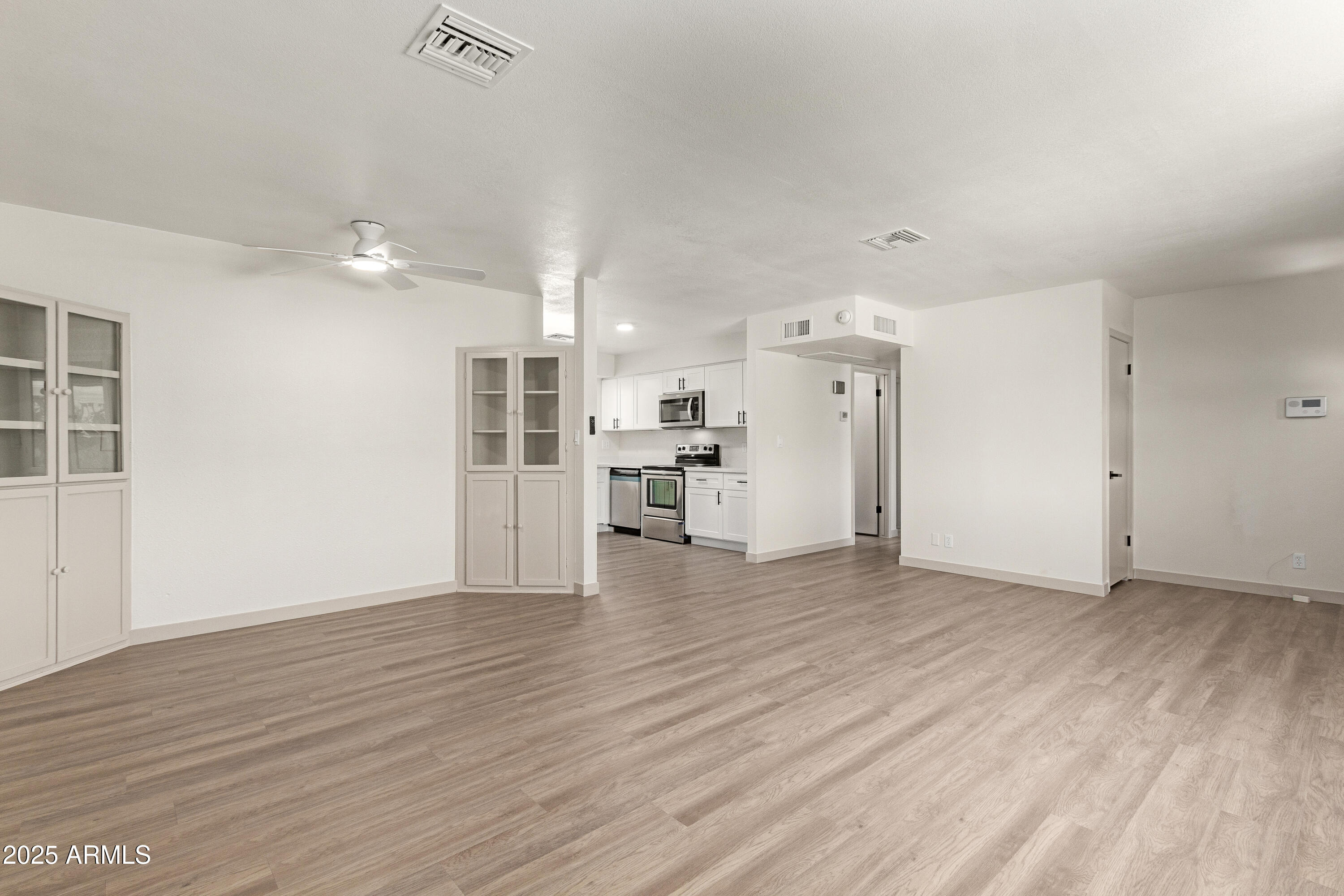 5732 Covina Road Mesa, AZ 85205 - Photo 4 of 24 wooden floor in an empty room with a kitchen