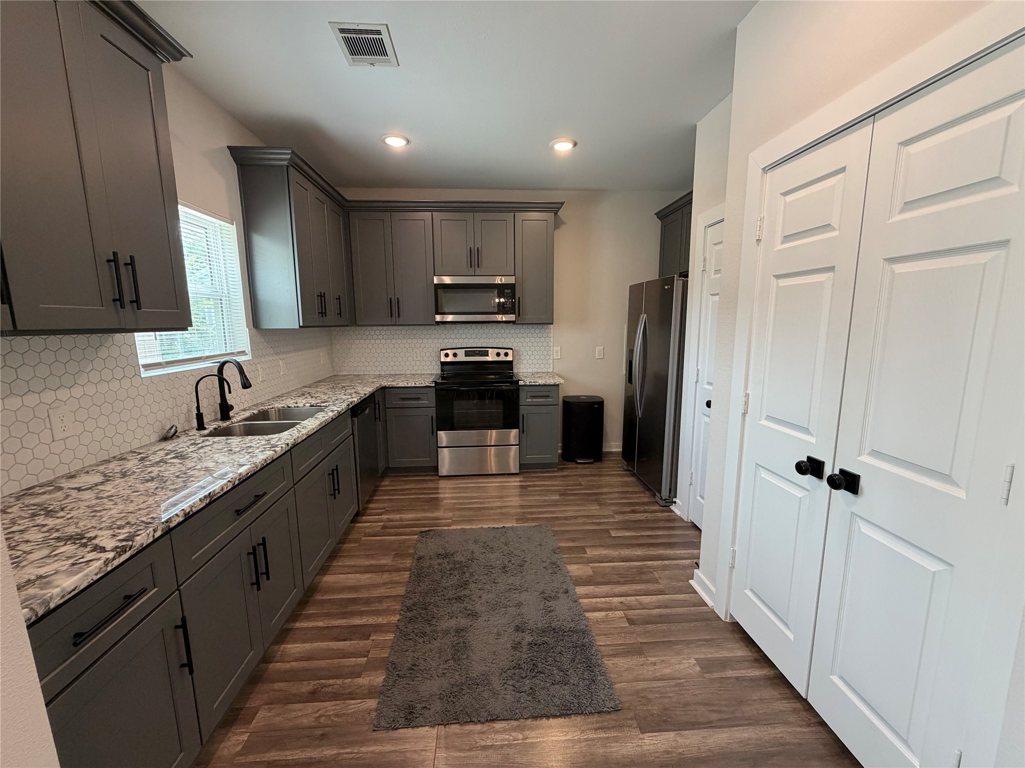 8049 Ritz Street, Unit B Houston, TX 77028 - Photo 2 of 19 Another view of Kitchen with Fridge, Pantry, and Washer/Dryer closet.