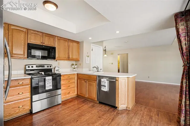 a kitchen with stainless steel appliances granite countertop a refrigerator and a sink