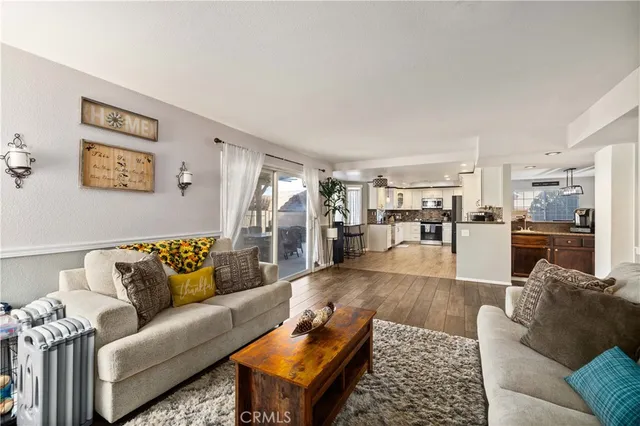 a living room with furniture and view of kitchen