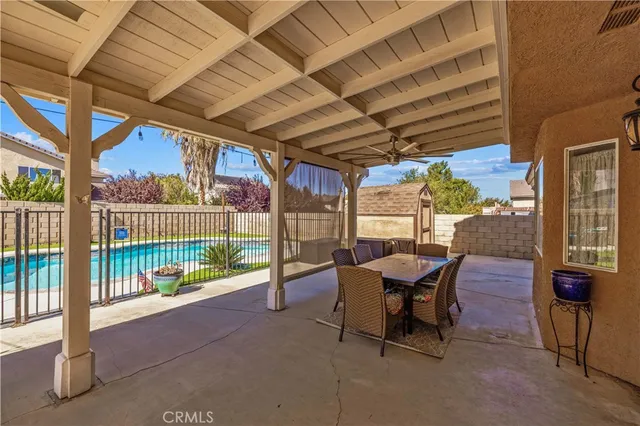 a view of a porch with furniture and a backyard