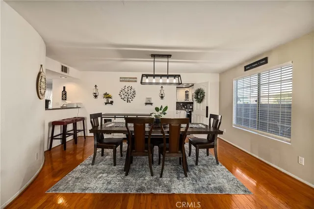 a dining room with furniture a rug and wooden floor