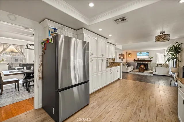 a kitchen with stainless steel appliances a refrigerator and wooden floor