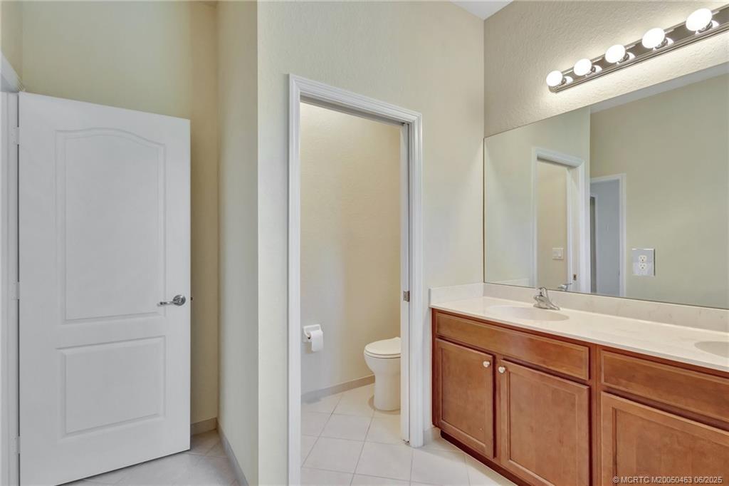 144 Southwest Otter Run Place Stuart, FL 34997 - Photo 11 of 20 a spacious bathroom with a double vanity sink and a mirror