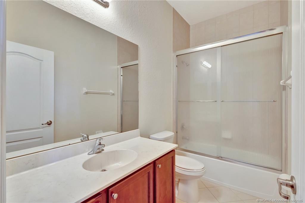 144 Southwest Otter Run Place Stuart, FL 34997 - Photo 13 of 20 a bathroom with a sink toilet and shower