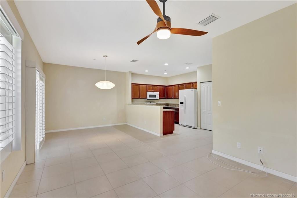 144 Southwest Otter Run Place Stuart, FL 34997 - Photo 6 of 20 a view of a kitchen with a sink and a refrigerator