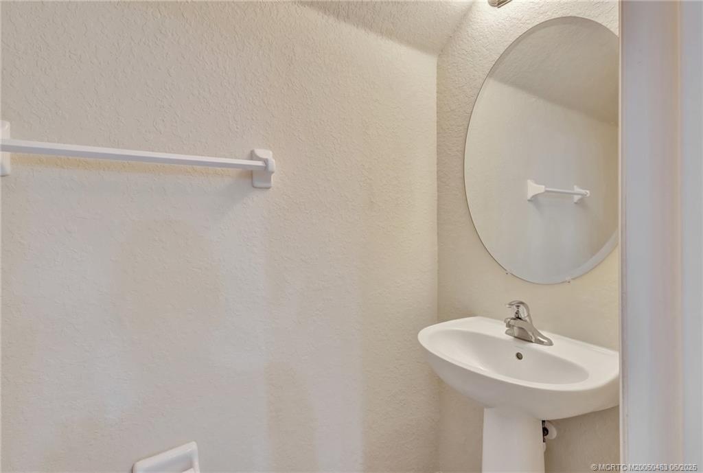144 Southwest Otter Run Place Stuart, FL 34997 - Photo 7 of 20 a bathroom with a sink a mirror and a shower