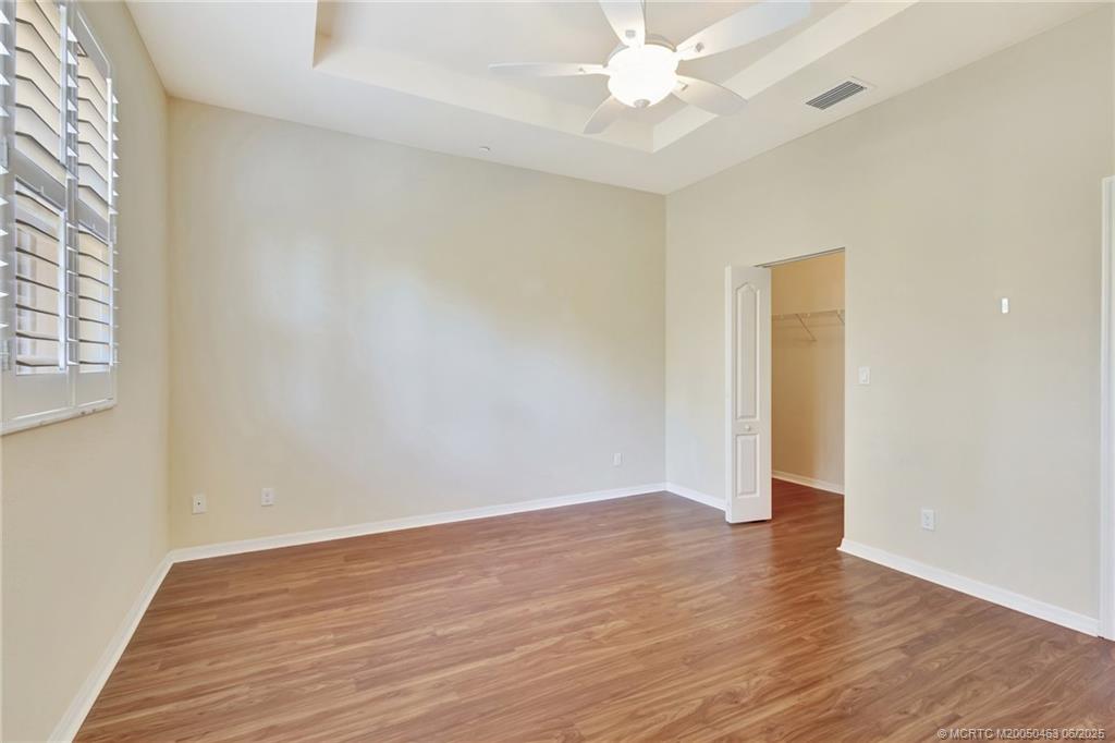 144 Southwest Otter Run Place Stuart, FL 34997 - Photo 8 of 20 an empty room with wooden floor and fan