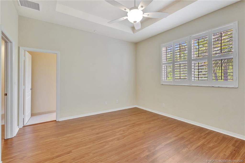 144 Southwest Otter Run Place Stuart, FL 34997 - Photo 9 of 20 a view of an empty room with wooden floor and a window