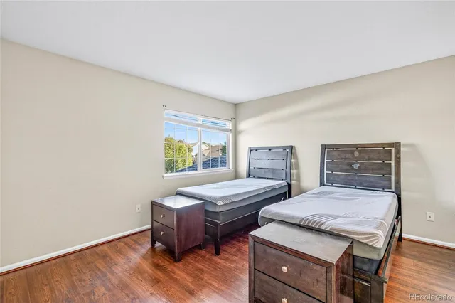 a bedroom with two beds and a desk