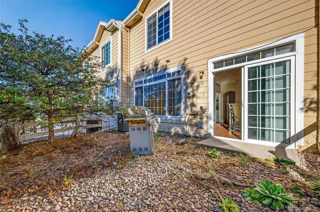 a view of a house with backyard and sitting area