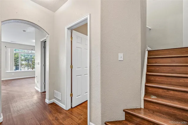 a view of a hallway with wooden floor and entryway