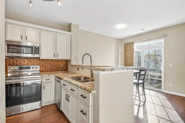 a kitchen with a stove a sink and a refrigerator
