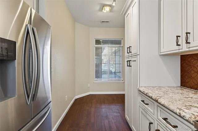 an empty room with wooden floor and a window