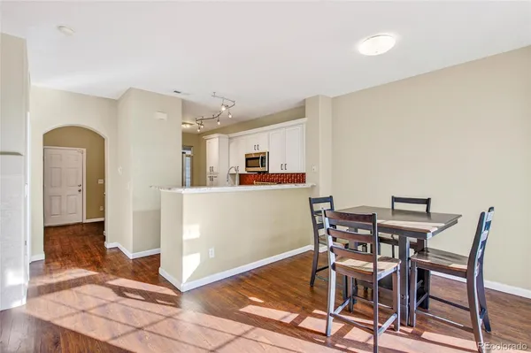 a view of a kitchen with dining area and entryway