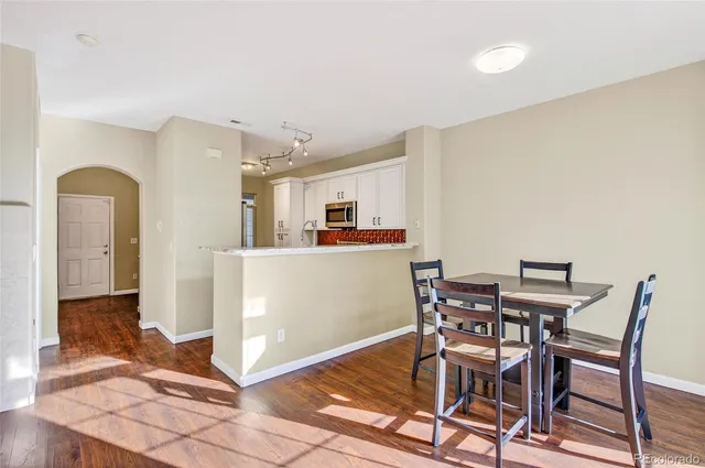a view of a kitchen with dining area and entryway