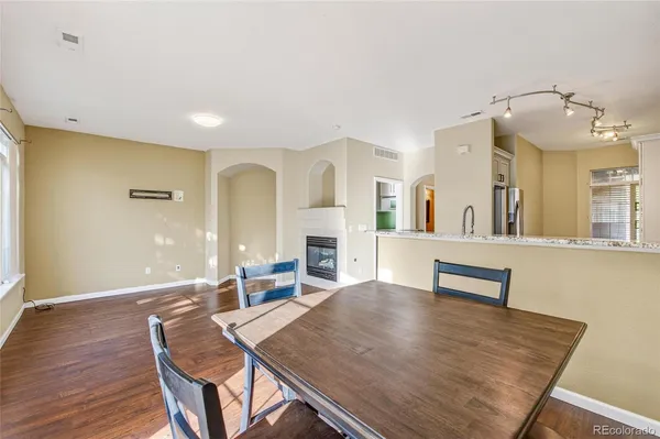 a view of a dining room with furniture and wooden floor