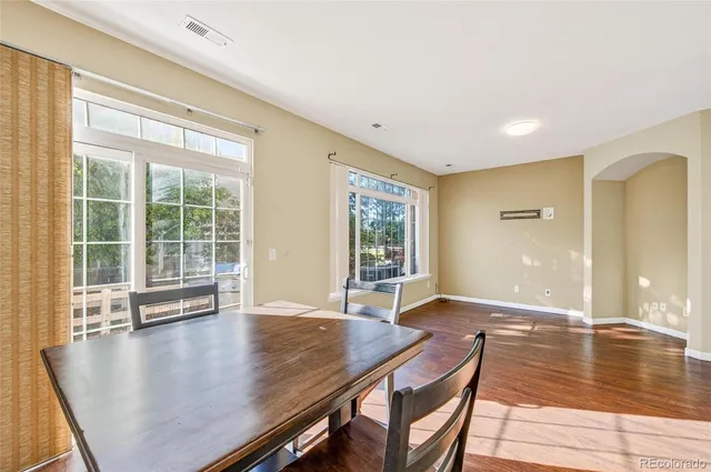 a view of a dining room with furniture window and wooden floor