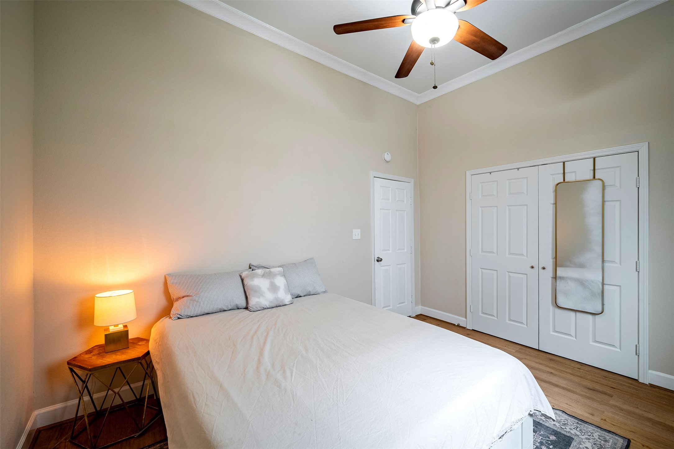 1924 Gano Street Houston, TX 77009 - Photo 11 of 18 a bedroom with a bed and a chandelier