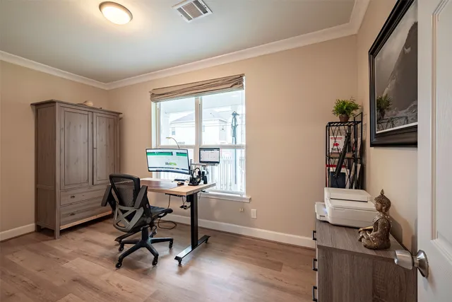 a view of a workspace with furniture and a window