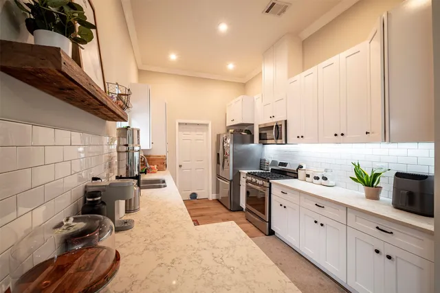a kitchen with refrigerator a stove and a wooden cabinets