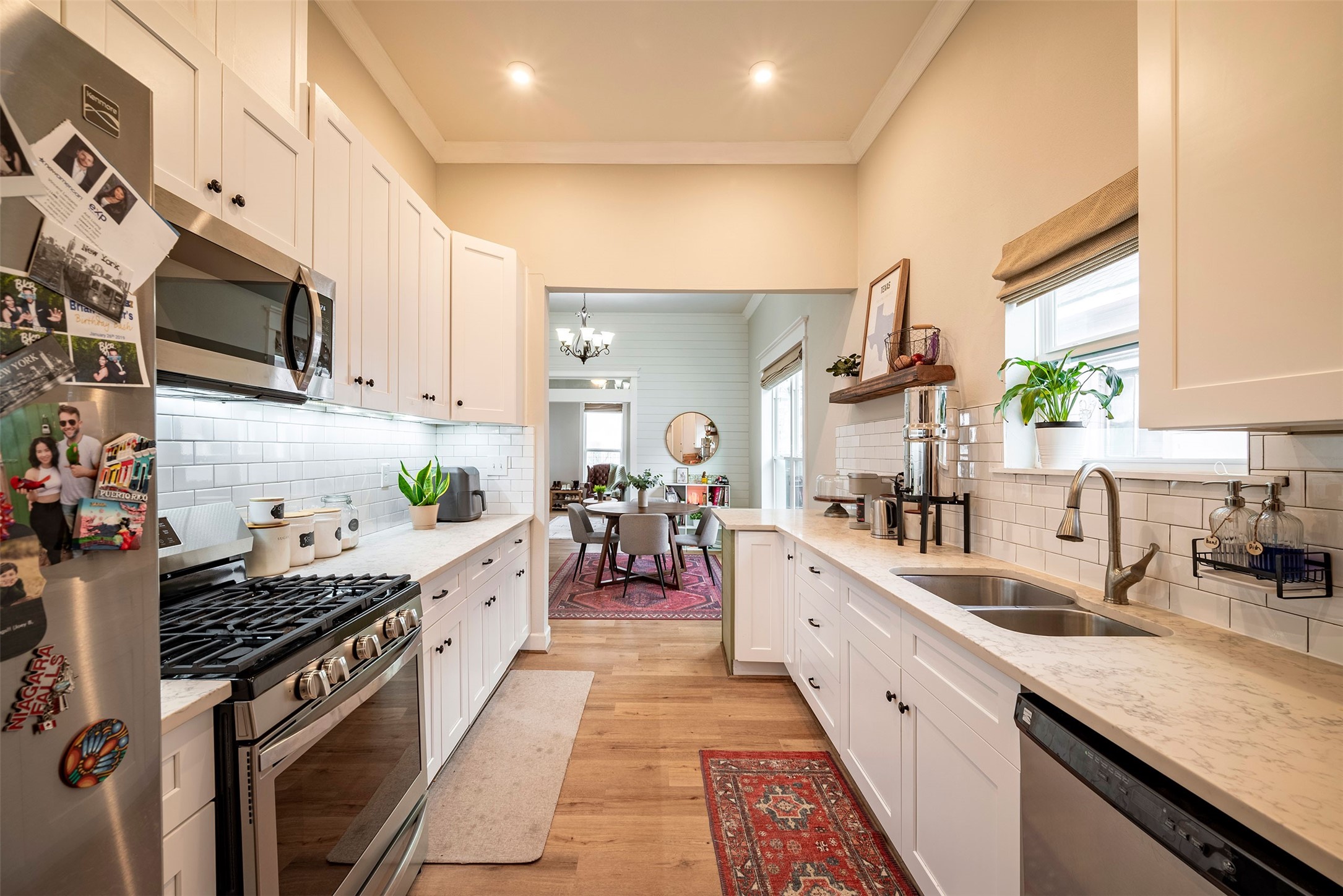 1924 Gano Street Houston, TX 77009 - Photo 7 of 18 a large kitchen with stainless steel appliances kitchen island granite countertop a lot of counter space and a sink