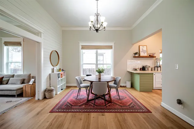 a living room with furniture a window and a chandelier