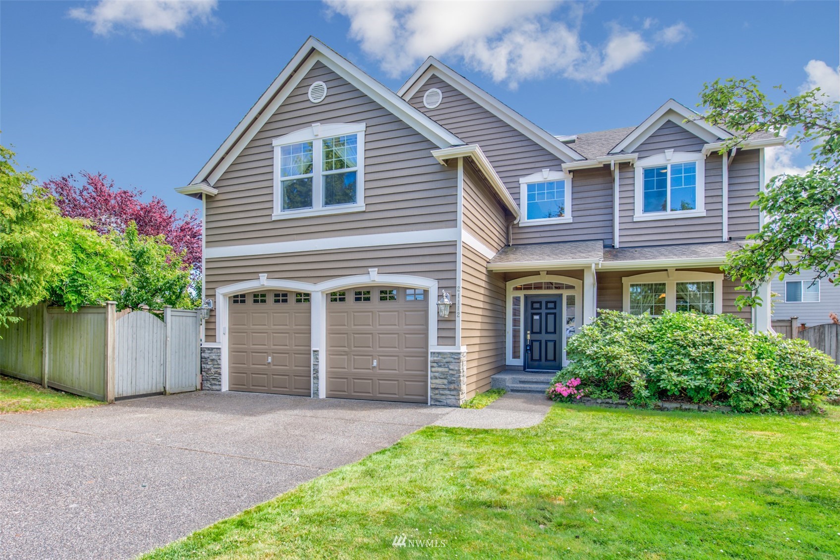 21112 39th Avenue Southeast Bothell, WA 98021 - Photo 1 of 33 a front view of a house with a yard and garage