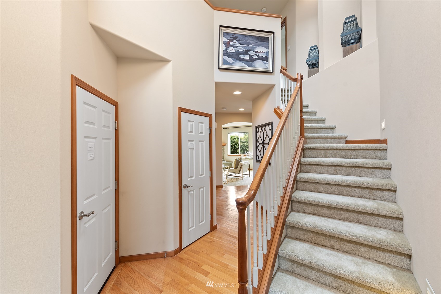 21112 39th Avenue Southeast Bothell, WA 98021 - Photo 2 of 33 a view of a hallway with paintings on the wall