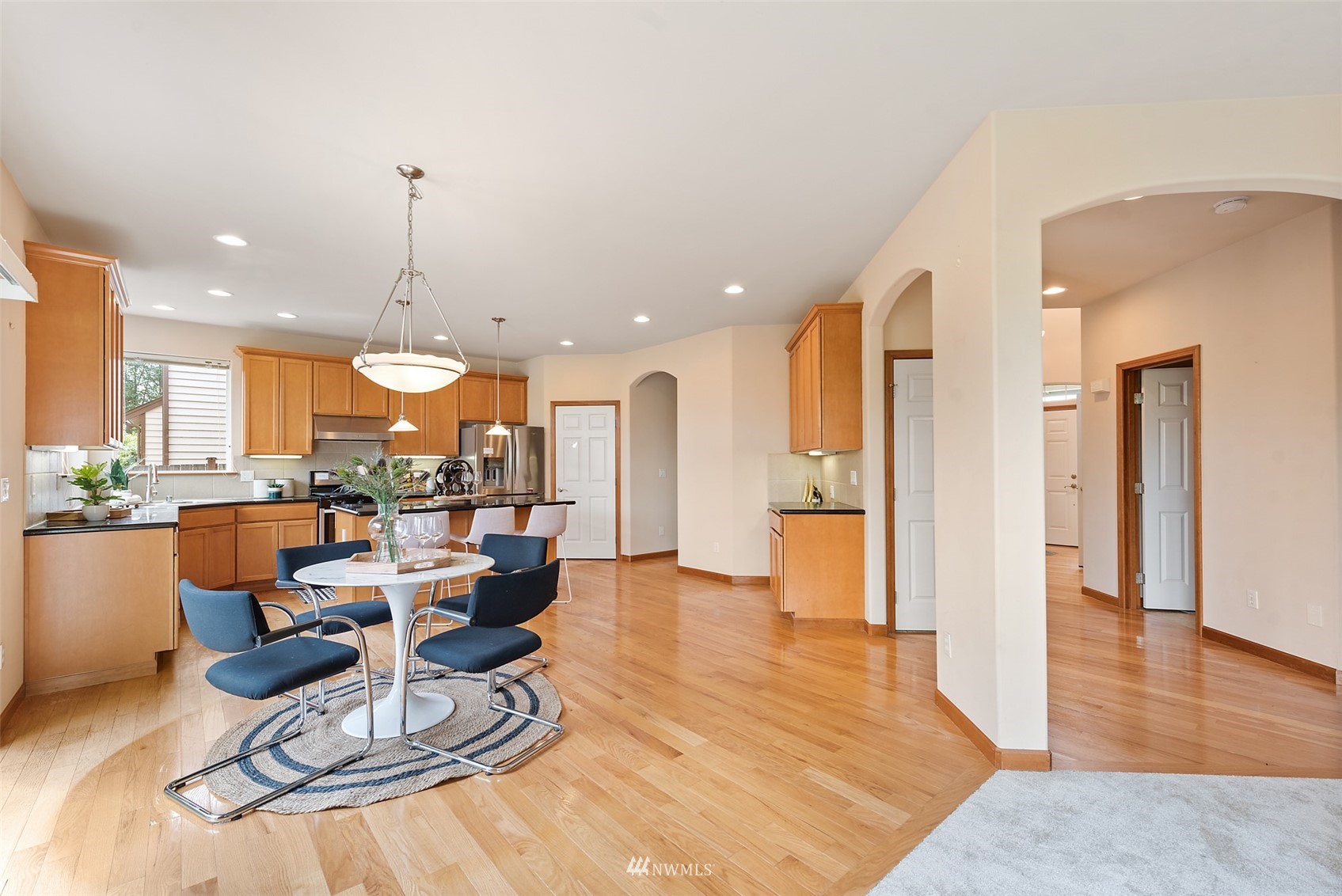 21112 39th Avenue Southeast Bothell, WA 98021 - Photo 7 of 33 an open kitchen with dining table and appliances