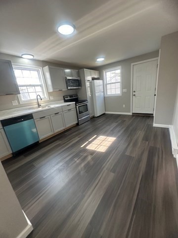 15-17 Otis Court, Unit 15 Springfield, MA 01119 - Photo 4 of 16 a large kitchen with cabinets wooden floor and stainless steel appliances