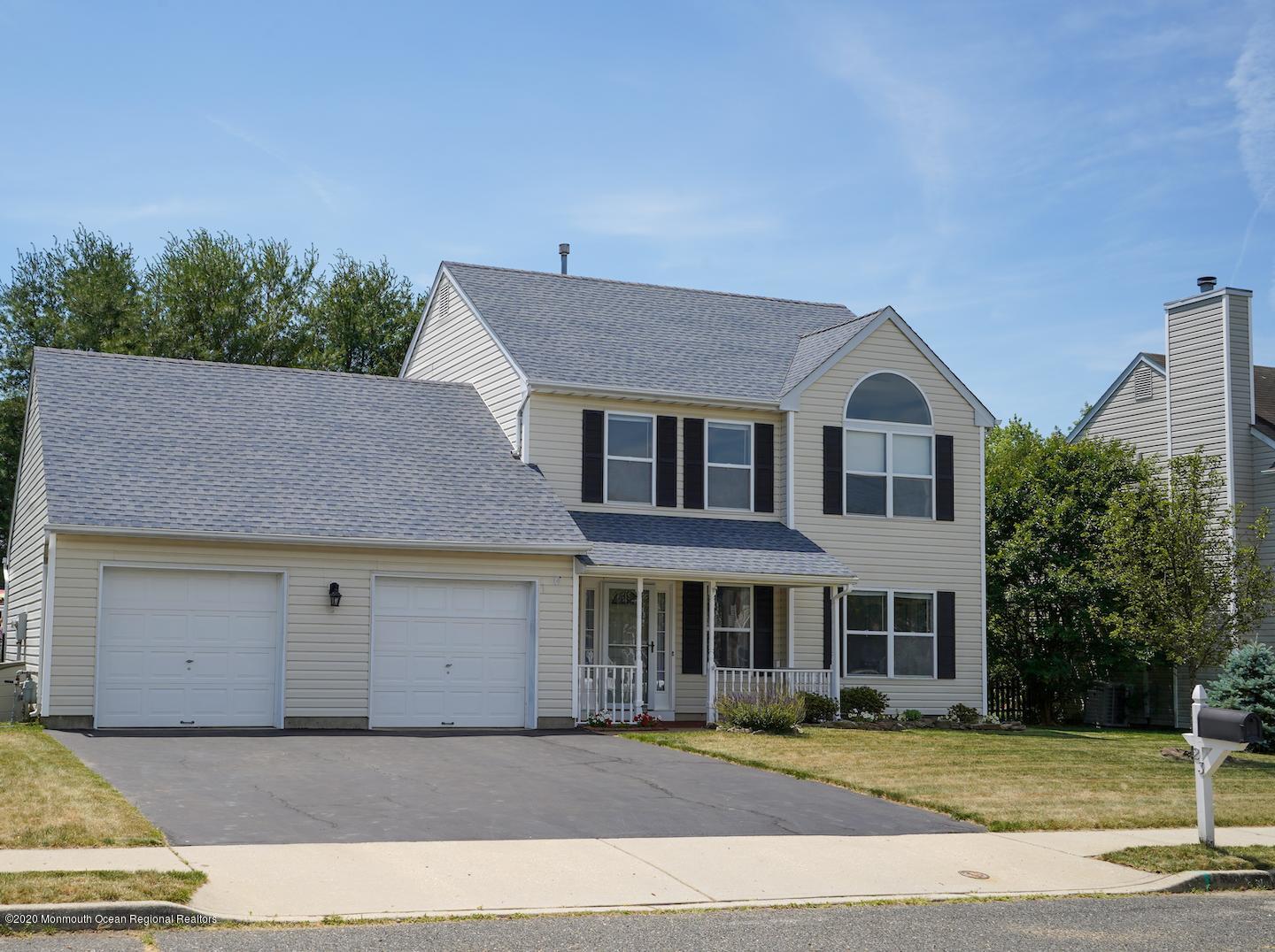 23 Crater Lake Road Howell, NJ 07731 - Photo 1 of 34 a front view of a house with a garden