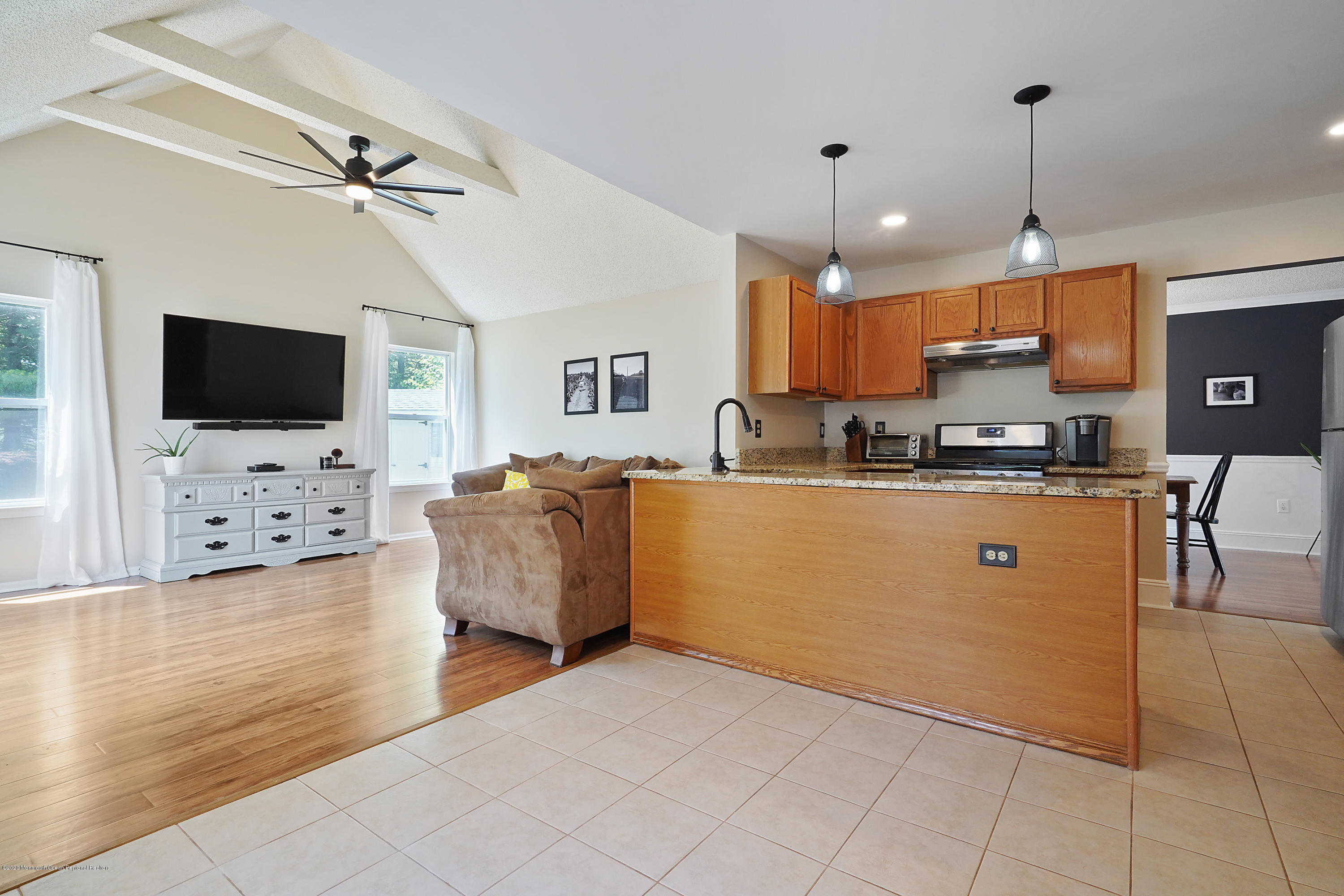 23 Crater Lake Road Howell, NJ 07731 - Photo 13 of 34 a living room with stainless steel appliances furniture and a flat screen tv
