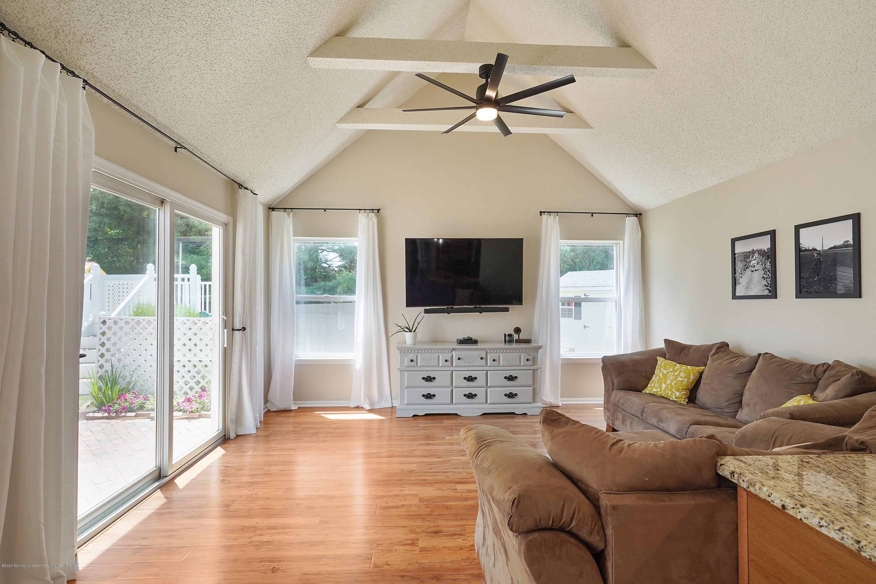 23 Crater Lake Road Howell, NJ 07731 - Photo 16 of 34 a living room with furniture a flat screen tv and a large window
