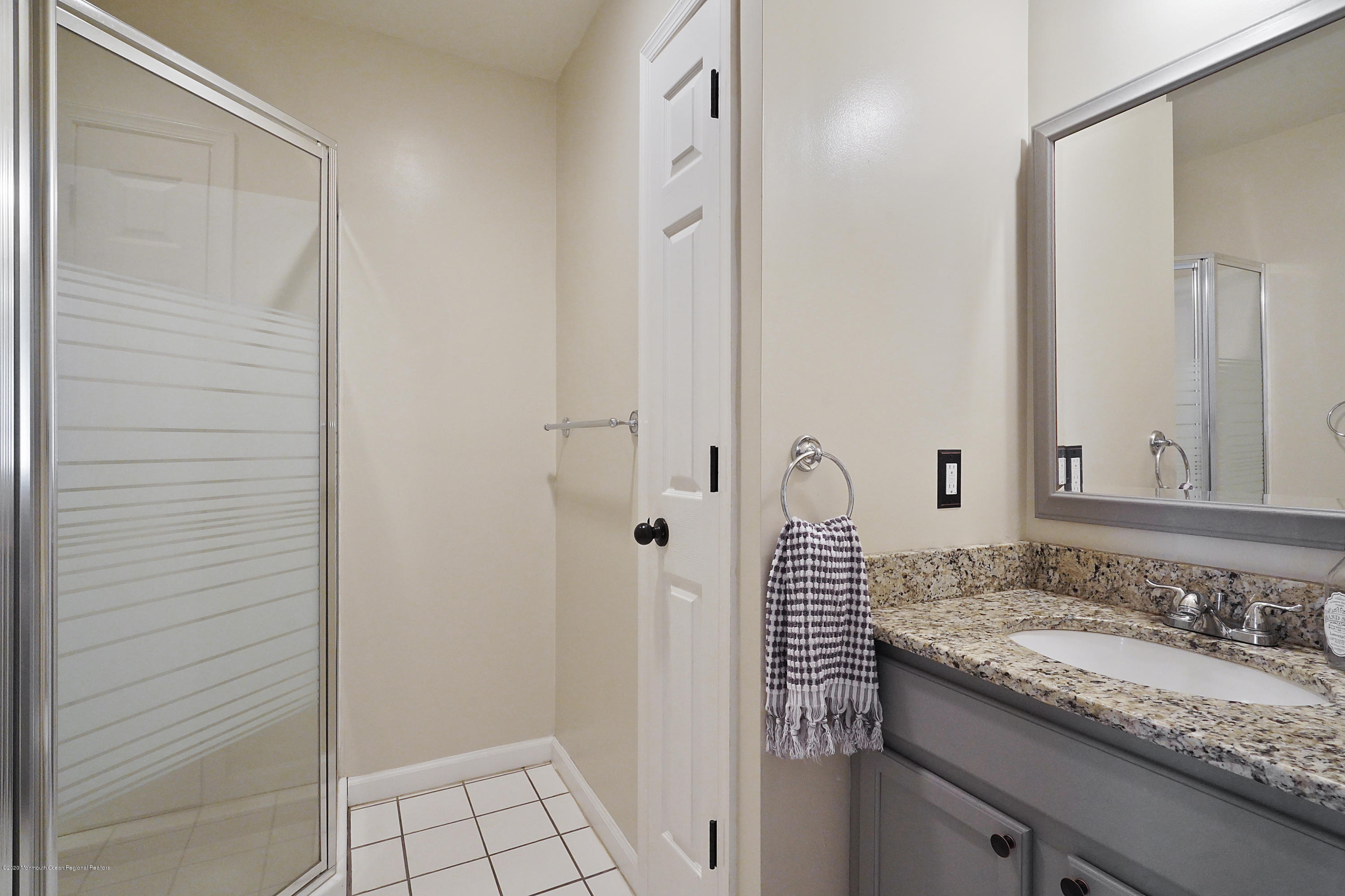 23 Crater Lake Road Howell, NJ 07731 - Photo 22 of 34 a bathroom with a granite countertop sink and a mirror