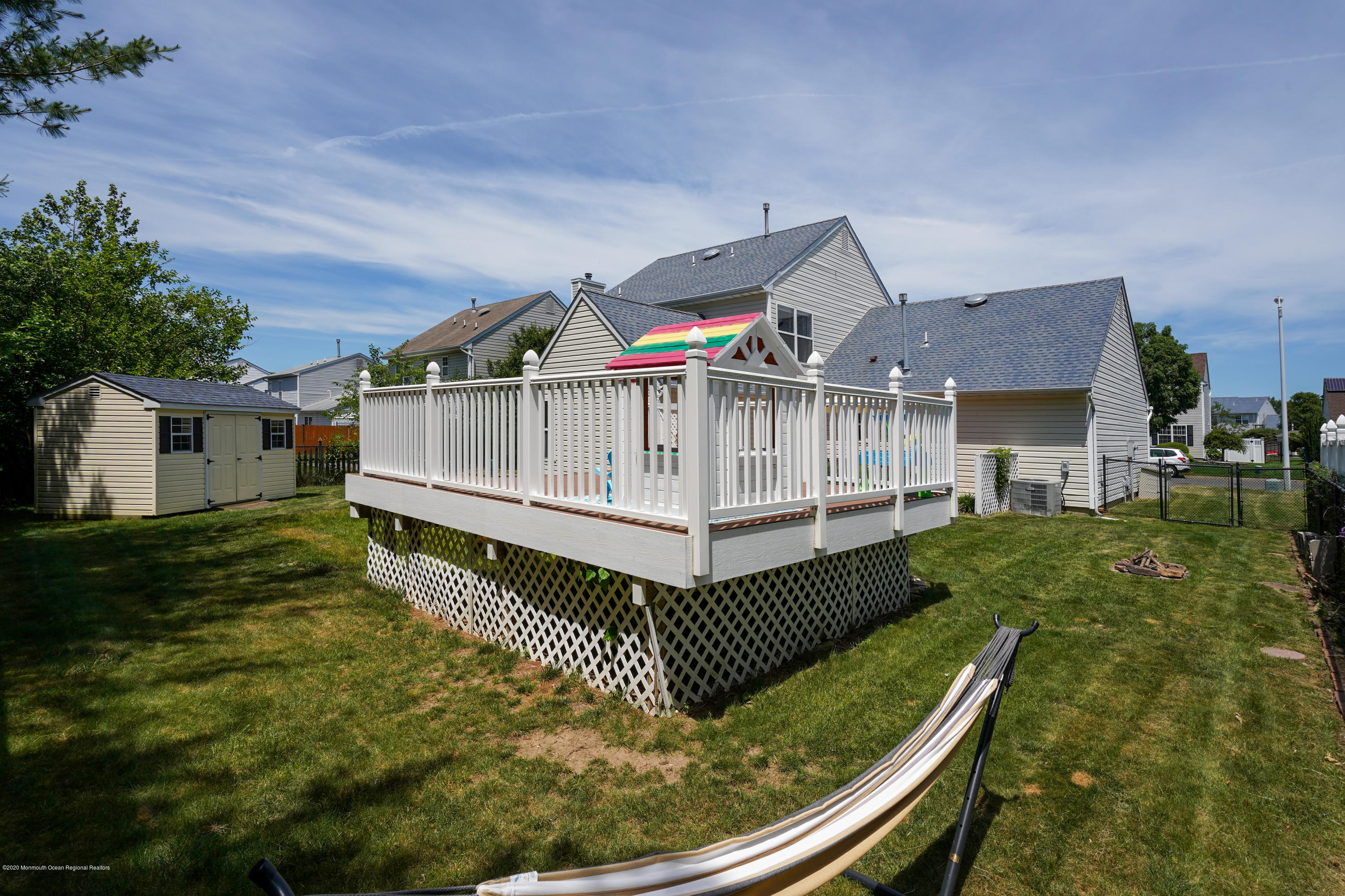 23 Crater Lake Road Howell, NJ 07731 - Photo 30 of 34 a view of a house with a wooden deck and a yard
