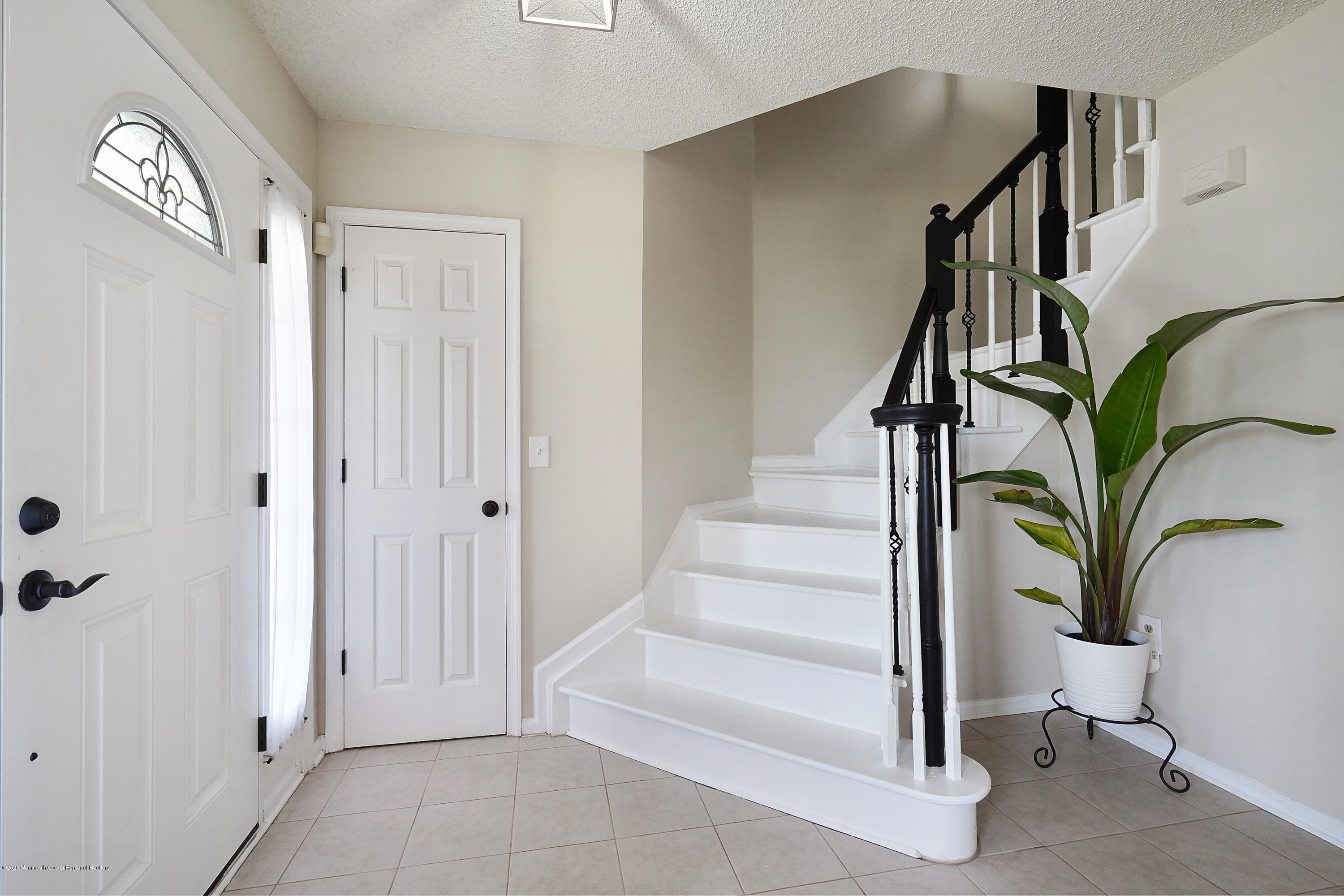 23 Crater Lake Road Howell, NJ 07731 - Photo 5 of 34 a view of staircase with white walls and a window