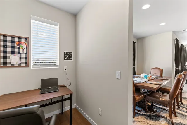 a view of a workspace with furniture and a window