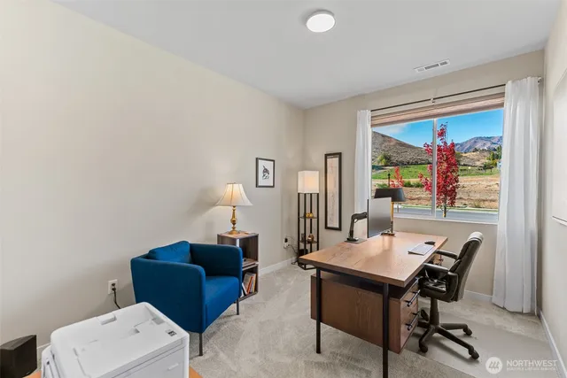 a view of a workspace with furniture