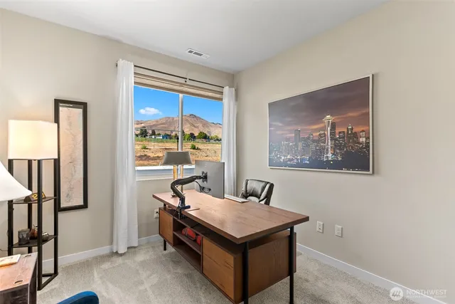 a room with pool table and windows