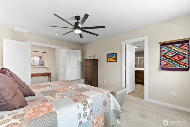 a bedroom with a large bed and a window