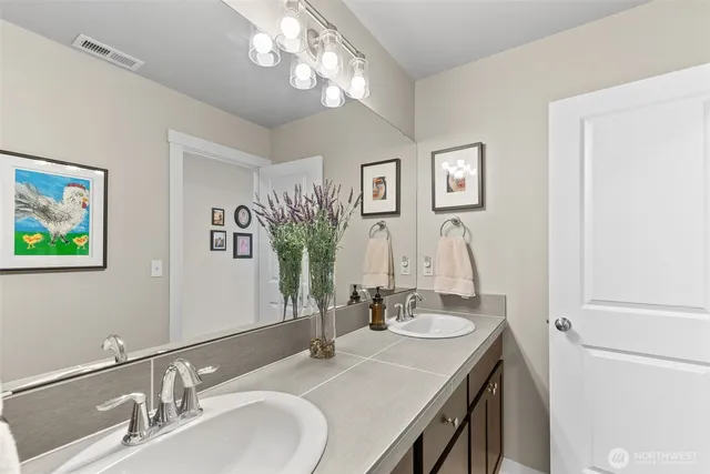a bathroom with a sink double vanity and a mirror