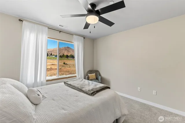 a bedroom with a large bed and a chandelier