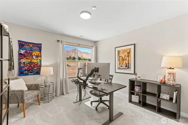 a view of a livingroom with furniture and a workspace