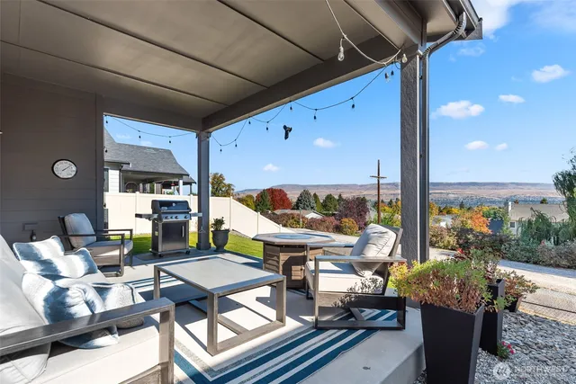 a roof deck with table and chairs